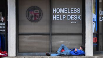 A man sleeps outside the Homeless Help Desk kiosk in the Skid Row community of Los Angeles, California.