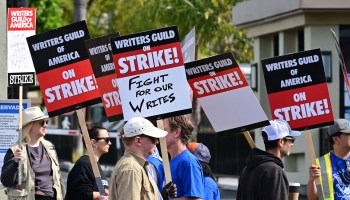 Writers hold signs while picketing in front of Paramount Studios in Los Angeles, California back in May. If the strike lasts for three months, it could cost the local economy $3 billion, according to one expert's estimate.