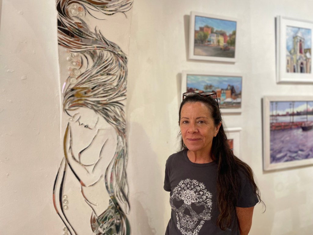 Luann Carra stands in her art gallery. 