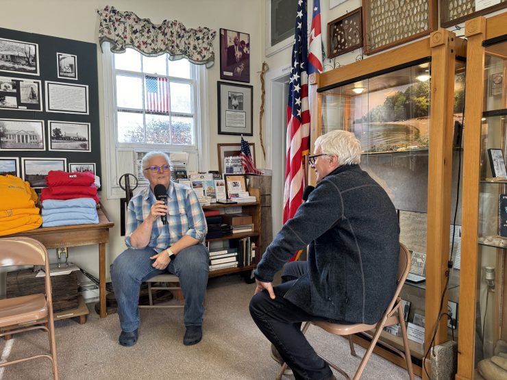 Renee Parker, president of the King George Historical Society, speaks with "Marketplace Morning Report" host David Brancaccio. They sit in the historical society, surrounded by historical area memorabilia and artifacts.